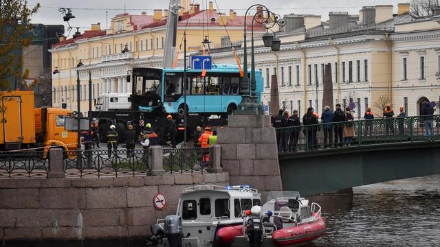 Rescuers work at the site where a bus plunged nto a river in Sr. Petersburg, Russia 