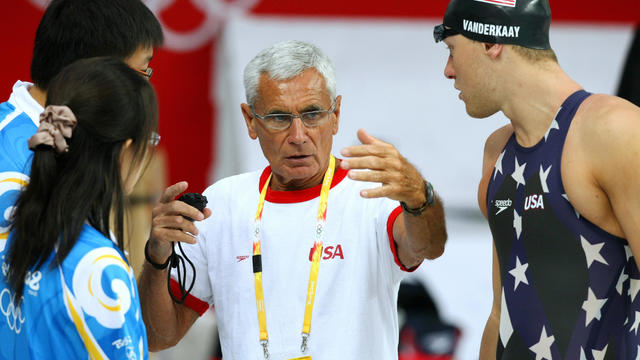 Swimming coach  Jon Urbanchek (C) talks 