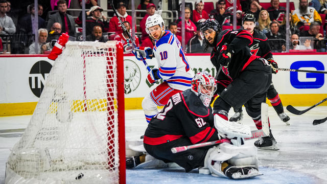 Artemi Panarin #10 of the New York Rangers scores a goal against Pyotr Kochetkov #52 of the Carolina Hurricanes to win the game in overtime in Game Three of the Second Round of the 2024 Stanley Cup Playoffs at PNC Arena on May 09, 2024 in Raleigh, North Carolina. 