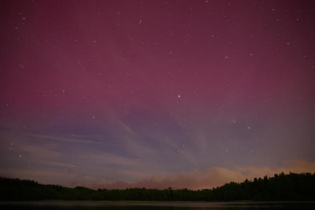 Northern lights are seen over the lake near Szczytno, Poland 