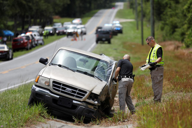 Florida Highway Patrol officers work on a vehicle believed to be involved in an accident with a bus near Dunnellon, Florida, May 14, 2024. 