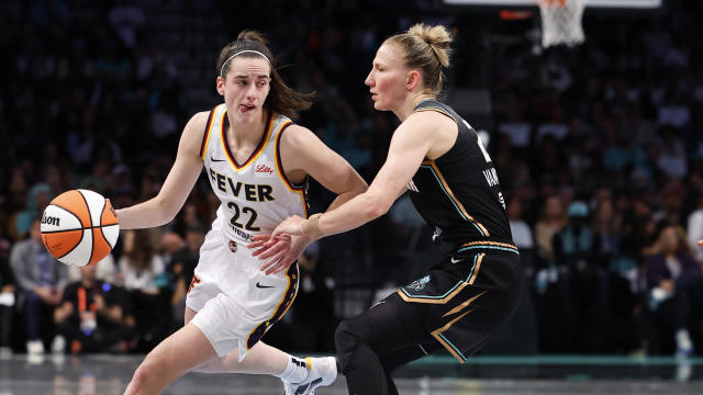 Indiana Fever guard Caitlin Clark (22) dribbles as New York Liberty guard Courtney Vandersloot (22) defends during the first half of a WNBA basketball game, Saturday, May 18, 2024, in New York. 