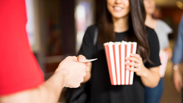 Woman ready to watch a movie at the theater 