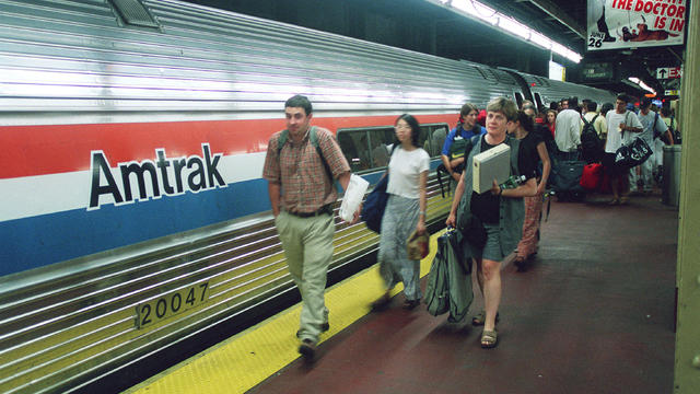 AMTRAK--Passenger board a Boston-bound Amtrak train at Penn 
