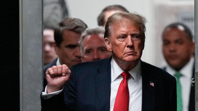 Former President Donald Trump gestures while returning from a break during his "hush money" trial at Manhattan Criminal Court on May 28, 2024, in New York City. 