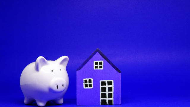 Fund , Investment , Saving money concept : Mock up White Piggy bank and House on blue background with copy space for text message - red pattern of Bank and Saving , benefit concept 