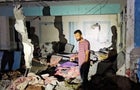 Palestinians inspect the site of an Israeli strike on a school sheltering displaced people in Nuseirat refugee camp in the central Gaza Strip 