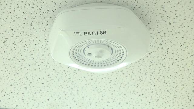 A vape detector on a bathroom ceiling 