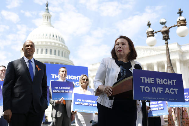 Sen. Tammy Duckworth speaks alongside Sen. Cory Booker outside of the U.S. Capitol on June 12, 2024, in Washington, D.C.  