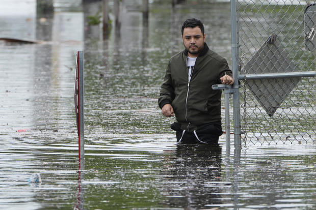 Francisco Lopez stands near the flooded parking lot of his apartment building on June 13, 2024, in Hallandale, Florida. 