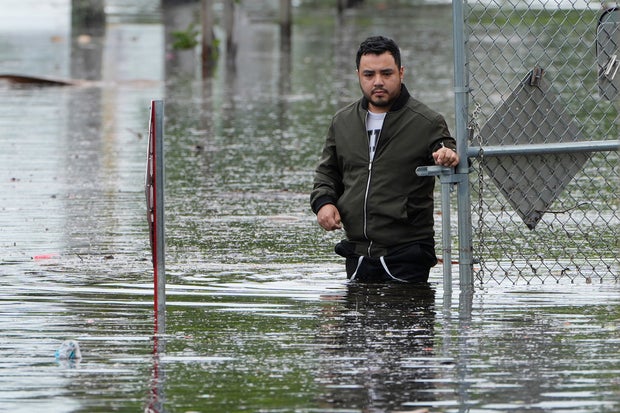 Francisco Lopez stands near the flooded parking lot of his apartment building on June 13, 2024, in Hallandale, Florida.