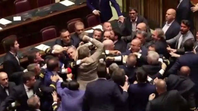 Italian lawmakers fight in Italy's Parliament in Rome, June 12, 2024, in an image capture from video. 