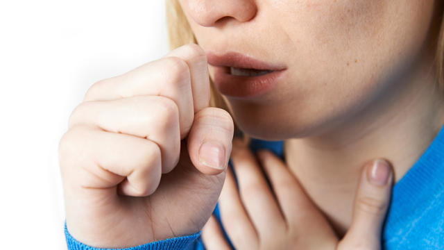 Close Up Of Woman Suffering With Cough 