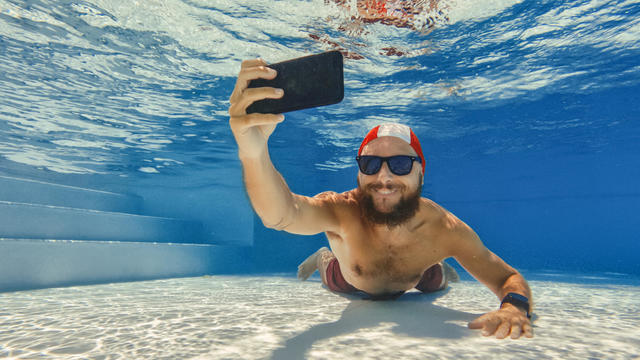 Man taking photos underwater 