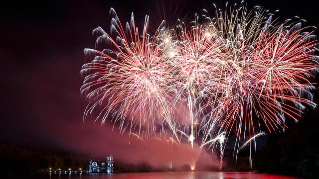 Astounding fireworks reflects in the water surface 