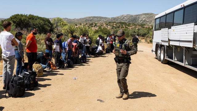 Migrants wait to be processed by the U.S. Border Patrol after crossing the U.S.-Mexico border on June 18, 2024, in Jacumba Hot Springs, California. 