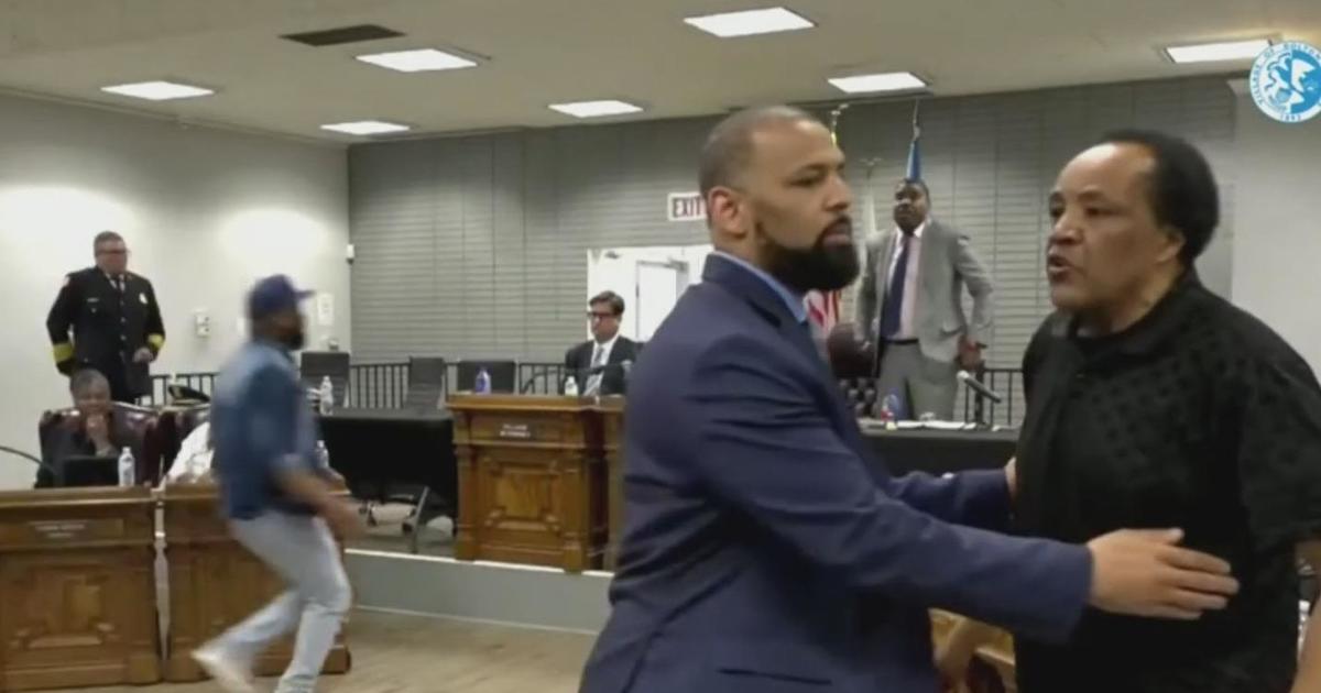 Activist taken away in handcuffs after confrontation with Andrew Holmes at Dolton board meeting