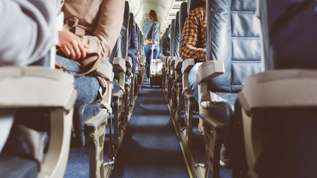 Airplane interior with people sitting on seats 