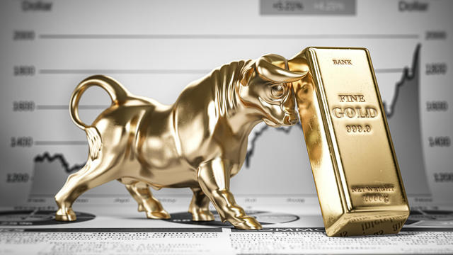 Golden ingot and bull on graph.  Bull market trend in gold. 