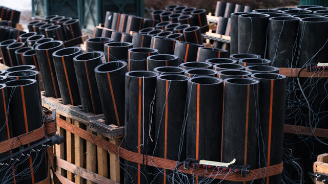 Preparation of big firework show with tubes filled with gunpowder and electric wire on ground. Fireworks festival, entertainment, danger. 