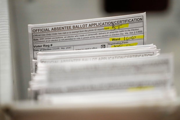 Absentee ballots are seen during a count in Milwaukee on Tuesday, Nov. 8, 2022.