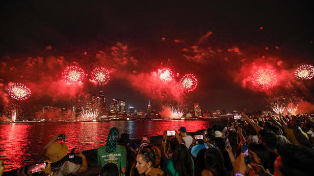 People gather near the Hudson River during the annual Macy's Independence Day fireworks show as seen from Hoboken, New Jersey, on July 4, 2024. 