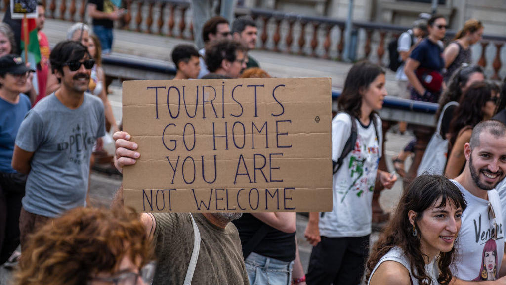 Spanish anti-tourism protesters take aim at Barcelona visitors with
water guns