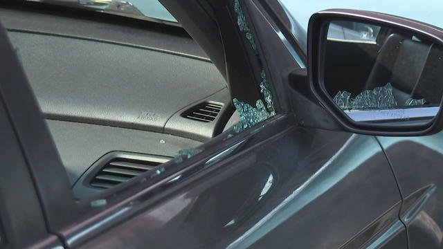 A car is shown with a broken window 