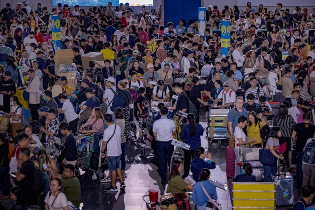 Long lines of passengers form at check-in counters at Ninoy Aquino International Airport amid a global IT disruption caused by a Microsoft outage and a CrowdStrike problem July 19, 2024, in Manila, Philippines. 
