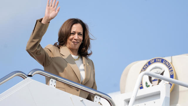 Vice President and Democratic presidential candidate Kamala Harris waves while boarding Air Force Two from Westfield-Barnes Regional Airport in Westfield, Massachusetts, on July 27, 2024, as she returns to Washington, DC, after attending a campaign fundraising event. 