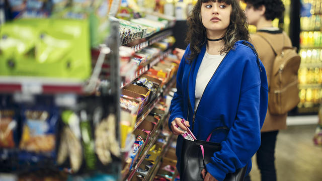 Young Woman Shoplifting in a Convenience Store 