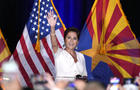 Republican Arizona Senate candidate Kari Lake waves to supporters as she arrives on stage after being declared the primary winner Tuesday, July 30, 2024, in Phoenix. 