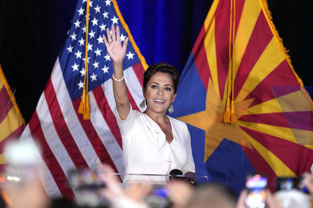Republican Arizona Senate candidate Kari Lake waves to supporters as she arrives on stage after being declared the primary winner Tuesday, July 30, 2024, in Phoenix. 
