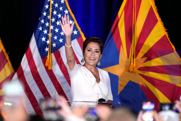 Republican Arizona Senate candidate Kari Lake waves to supporters as she arrives on stage after being declared the primary winner Tuesday, July 30, 2024, in Phoenix.