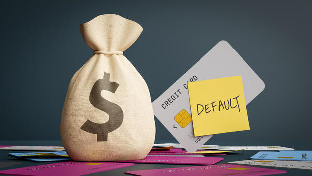 Money bags with the concept of personal credit delinquency and credit cards with a 'default' memo, 3d rendering 