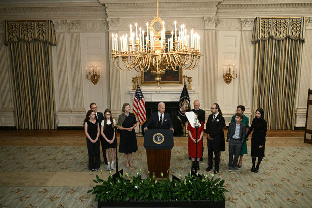 President Biden stands alongside family members of Americans freed in a prisoner swap with Russia at the White House on Aug. 1, 2024. 