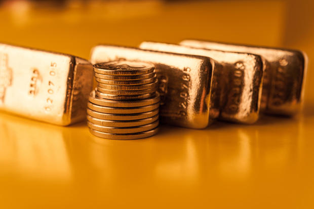 Gold bars and stack of gold coins. Background for finance banking concept. Trade in precious metals. 