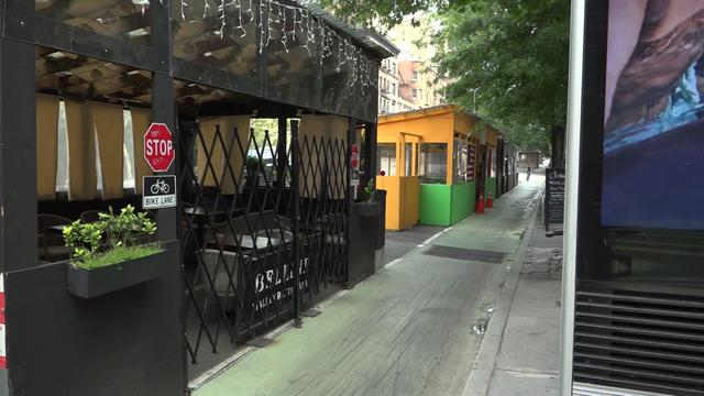 Two roadside dining structures on a New York City street. 