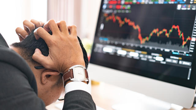 Businessman grabs the head concept with business chart on scoreboard 