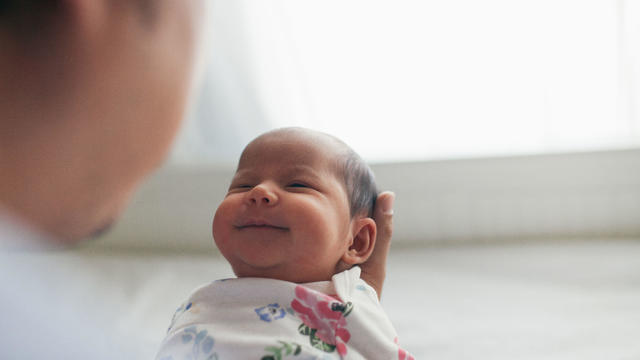 Father holding newborn daughter 