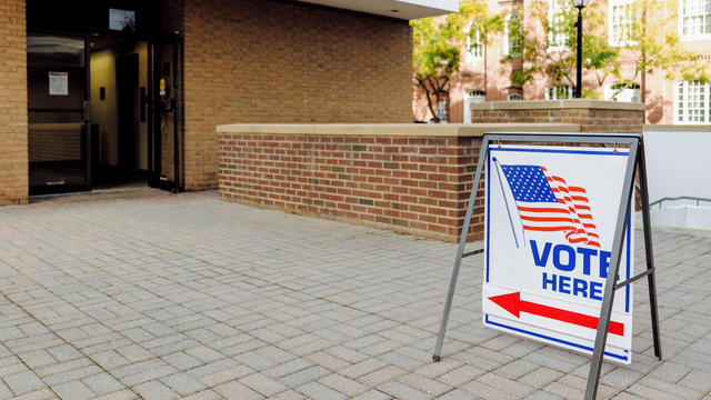 "Vote Here" Directional Sign Outside of Polling Place 