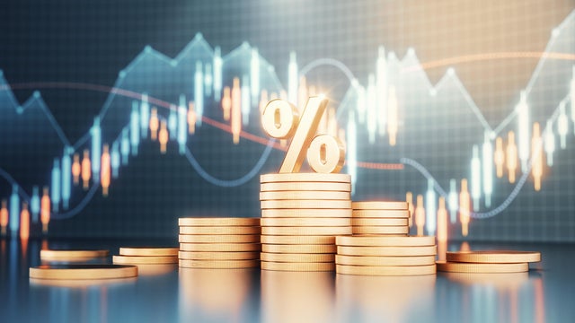 Percent Sign Standing on Metal Coins on Finance Background 