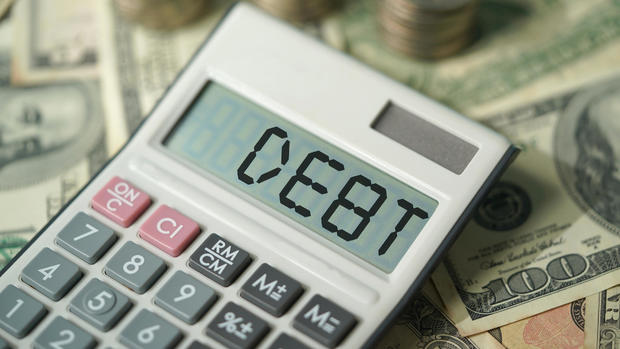 DEBT , calculator and american dollar with coins, financial concept photo 