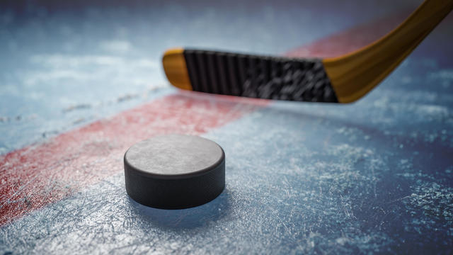 Hockey puck on ice at stadium. 3D rendered illustration. 