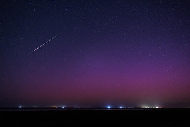 Northern Lights and shooting stars in the night sky 