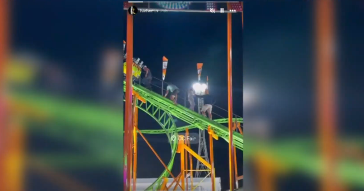 Passengers are escorted from a broken ride at the Orange County Fair