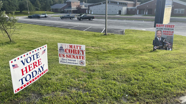 Signs for Matt Corey, a Republican candidate for U.S. Senate, stand posted outside the Sayles School in Sprague, Conn., Tuesday, Aug. 13, 2024, for a statewide primary. 