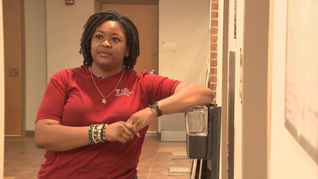 A student speaks to a reporter in her dorm hallway at Temple University 