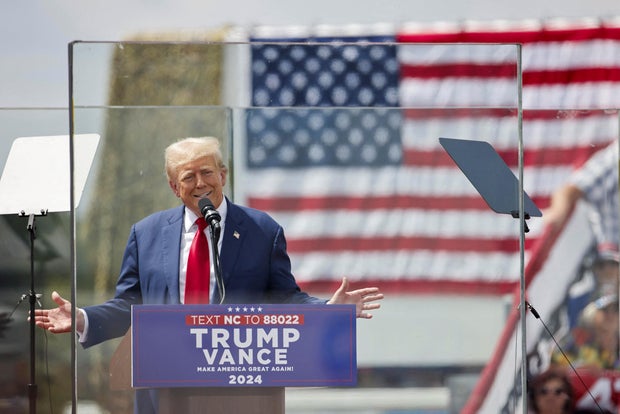 Former President Donald Trump speaks from a bulletproof glass housing during a campaign rally in Asheboro, North Carolina, on Aug. 21, 2024.