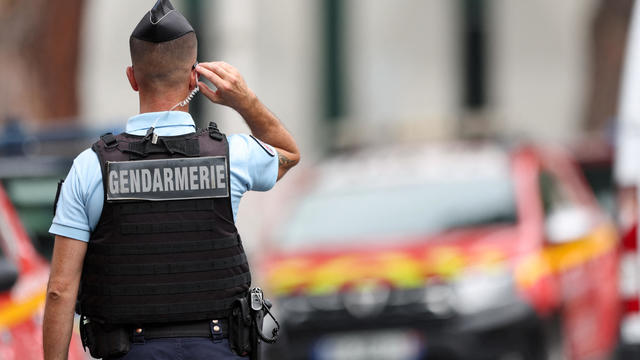 French police stand guard after cars were set on fire in front of the city's synagogue, in La Grande-Motte 